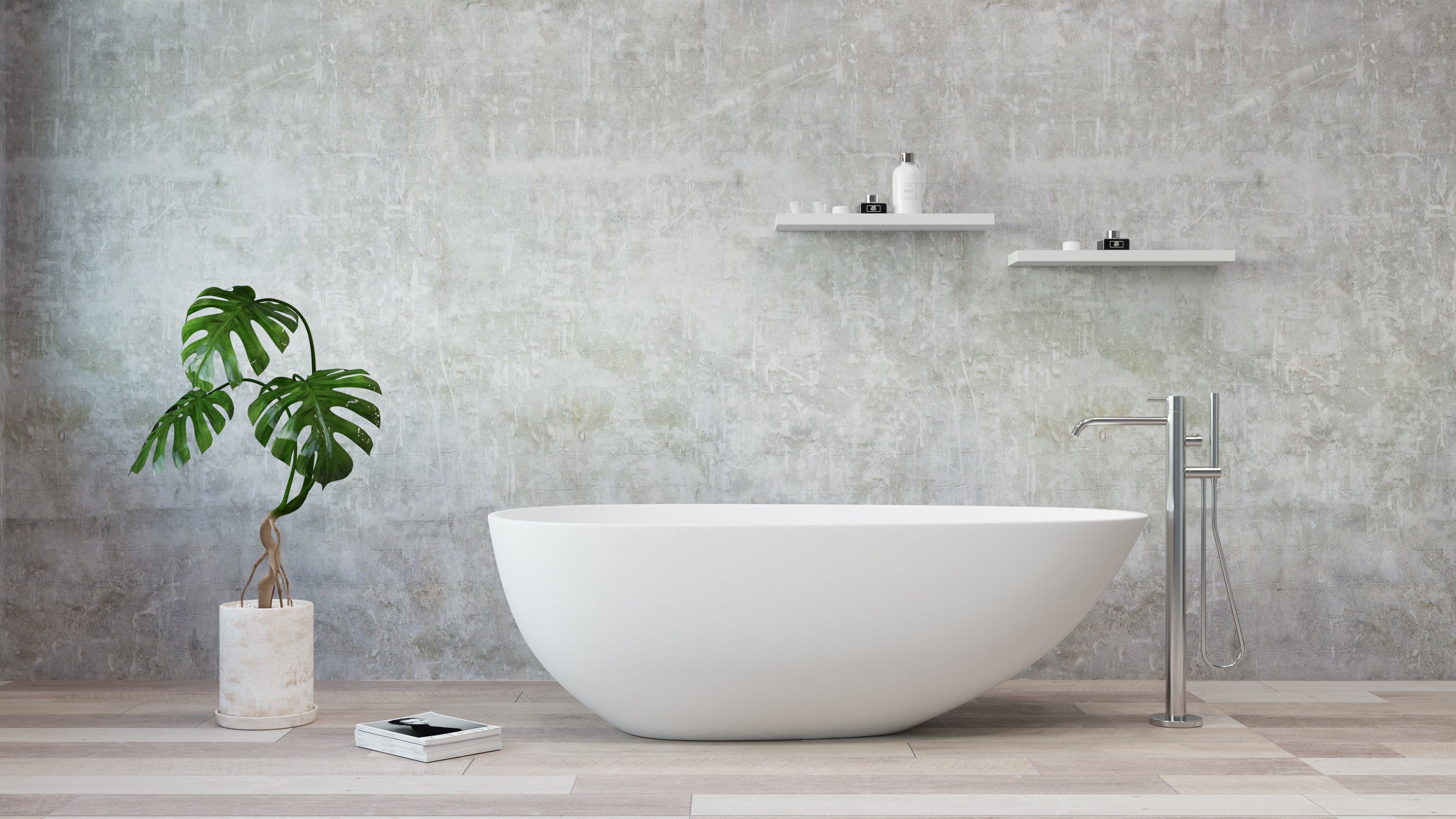 Modern bathroom with a white freestanding bathtub, plant, and shelves against a gray concrete wall.